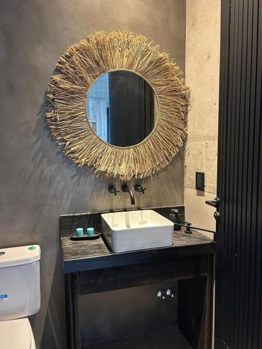 a bathroom with a sink and a mirror at Casa Rumenco Joven mdq in Mar del Plata