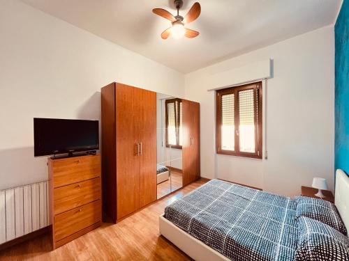 a bedroom with a bed and a flat screen tv at Be Your Home - Casa Vacanze Il Posticino in Civitavecchia