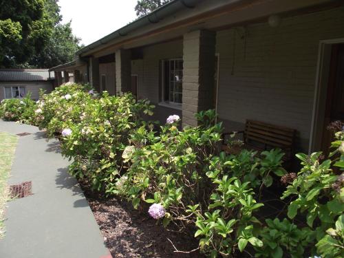 a garden of flowers in front of a house at Jock-Sabie Lodge in Sabie