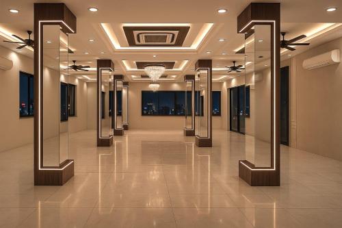 a hallway in a building with mirrors on the walls at Hotel A K CONTINENTAL in Rānchī