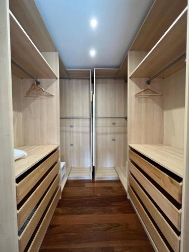 a walk in closet with wooden closets at APARTAMENTOs URDAIBAI 6 in Bermeo