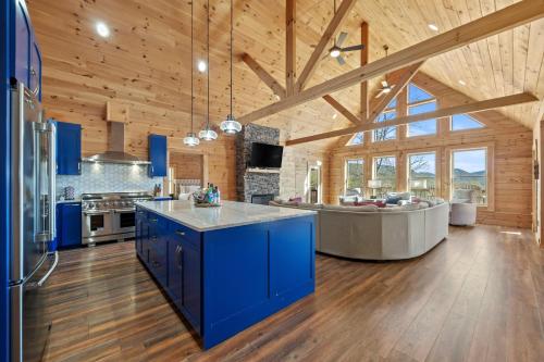 a large kitchen with blue cabinets and a blue island at Sunshine Hill in Fairview