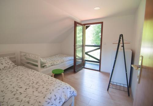 a bedroom with a bed and a window with a ladder at Grunthouse in Prebold