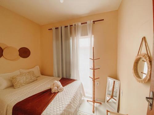 Ένα ή περισσότερα κρεβάτια σε δωμάτιο στο Raízes Guest House