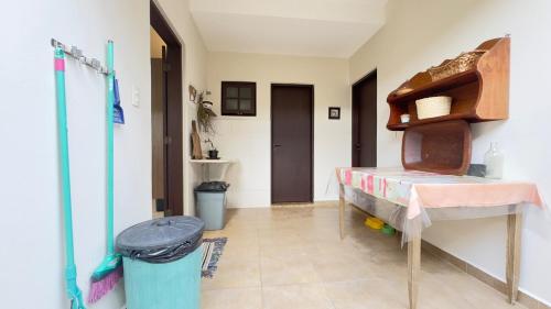 a room with a bed and a table in it at Aconchego e diversão em Peruíbe sobrado com estrutura completa para sua família ar condicionado, churrasqueira ,academia, cervejeira, piscina in Peruíbe