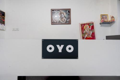 a sign that says oxy on a wall with pictures at SPOT ON New Phulpur Restaurant And Hotel in Phūlpur