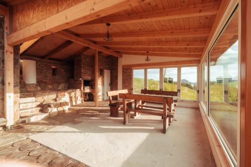 a porch of a house with a bench and windows at SkyView Dežno in Makole