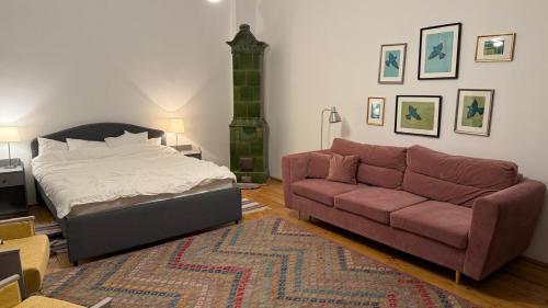a living room with a bed and a couch at Nostalgia in Turda