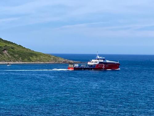 a red and white boat in a large body of water at The Gateway Suite in Fortune