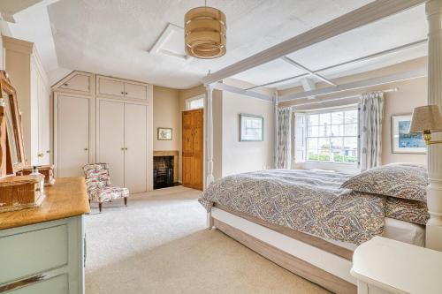 a bedroom with a bed and a window at Old Bell House - Spacious Period Home in the Heart of Somerton in Somerton