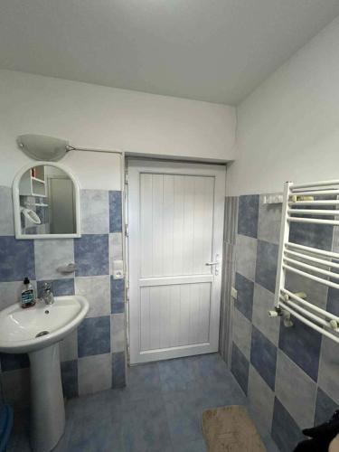a bathroom with a white door and a sink at Apartment 9 in Mtskheta