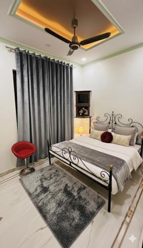 a bedroom with a bed and a red chair at Krishna guest house in Varanasi
