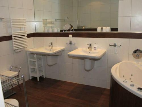 a bathroom with two sinks and a mirror at One-bedroom apartment in Sassnitz