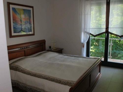 a bedroom with a large bed in front of a window at One-bedroom apartment in Sassnitz