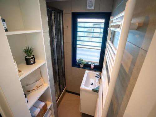 a small bathroom with a sink and a window at Schönes Hausboot in Höxter in Höxter
