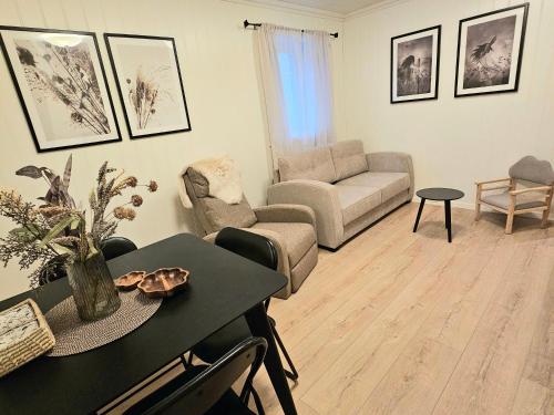 a living room with a couch and a table at Fin 3-roms leilighet i Harstad sentrum in Harstad