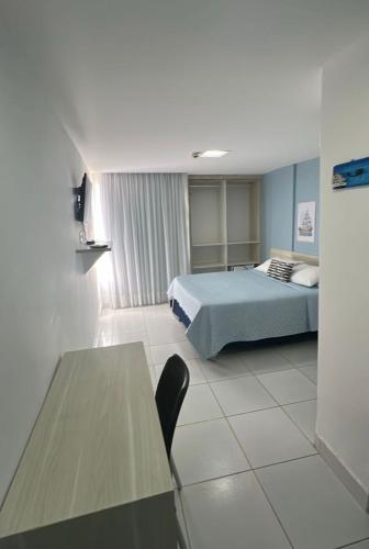 a hotel room with a bed and a table at Aracaju Corais Hotel in Aracaju