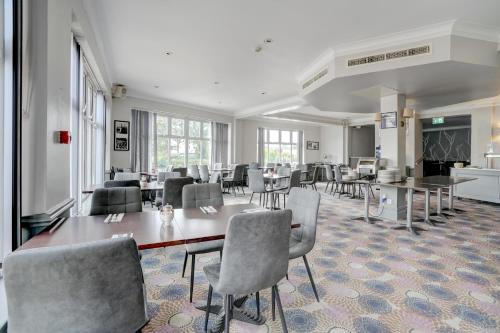 a dining room with a table and chairs at Sunday London Staines-upon-Thames Heathrow T5 in Staines