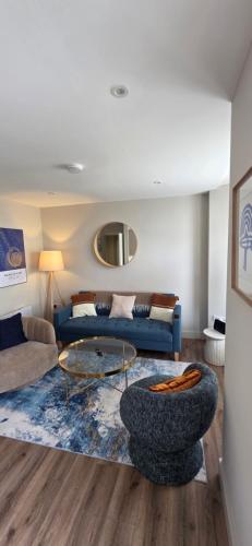 a living room with a couch and a table at Turtle Cove in Portrush