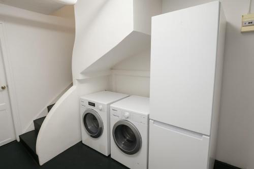 a laundry room with two washer and dryer at Spacious house with garden, 15 minutes from Paris in Houilles