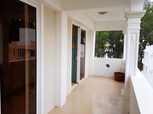 an empty hallway of a house with white walls at Beachfront two bedroom apartment-perfect sea escape! in Flic-en-Flac