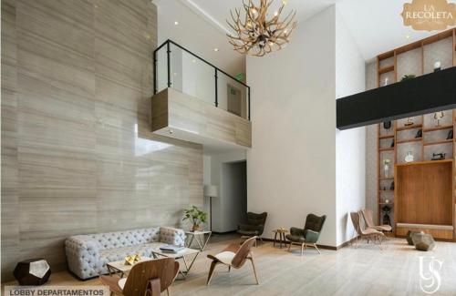 a living room with a couch and a staircase at Habitación en Quito in Quito