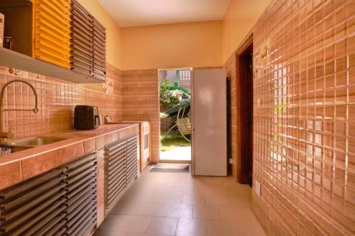 a kitchen with a sink and a counter top at Elegante villa avec Pool et près de la mer in Mbour