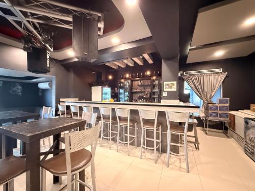 a bar in a restaurant with bar stools at Hotel Nieto Express in Matamoros