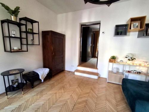 a living room with a couch and a wooden floor at Central Modern Studio - wifi, coffee in Bratislava