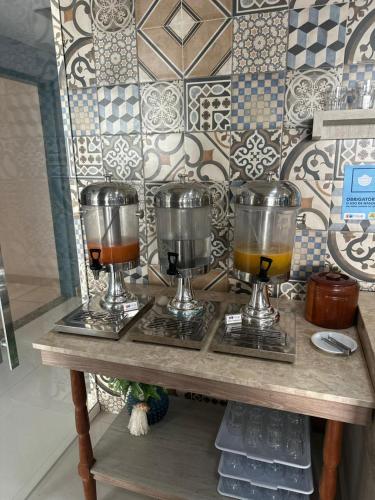 a wooden table with two wine glasses on it at Aracaju Corais Hotel in Aracaju