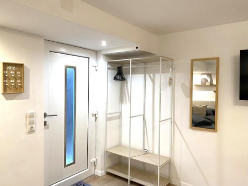 a dressing room with a glass door and a mirror at Allgäu-Nest mit Stellplatz in Durach