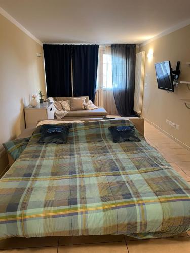 a bedroom with a large bed with a tv on it at Mondarco in Serravalle