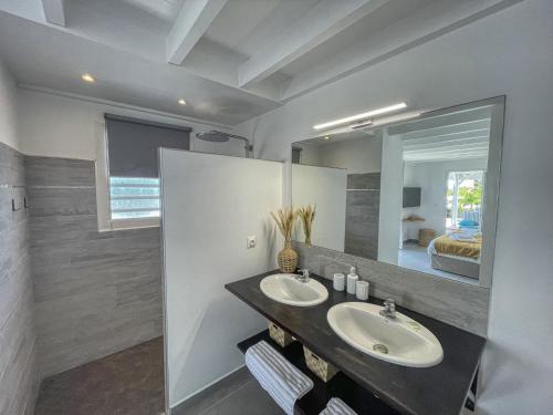 a bathroom with two sinks and a large mirror at GPSA83 - 8 pax in Fouché