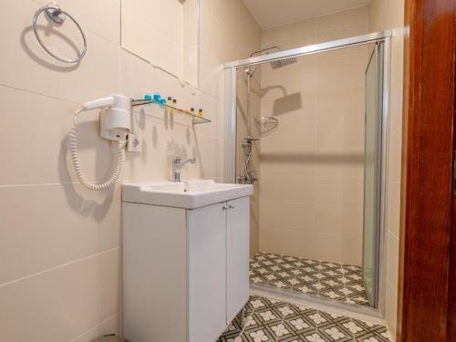 a white bathroom with a shower and a sink at Oldsophia hotels in Istanbul