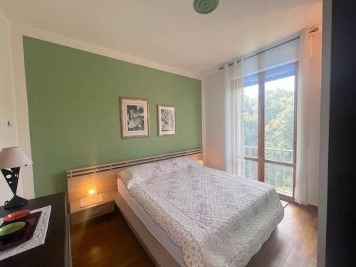 a bedroom with a bed and a large window at Appartamento vista mare in Castiglioncello
