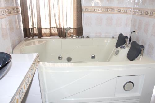 a white bath tub in a white bathroom at HOTEL NOGAL PLAZA in La Virginia