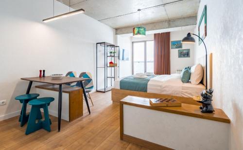 a bedroom with a bed and a desk and a table at New Gudauri Ski4Life in Gudauri
