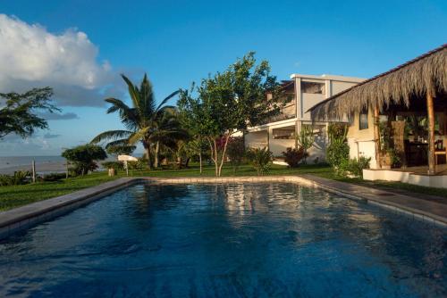 a swimming pool in front of a house at Casa Babi in Vilanculos