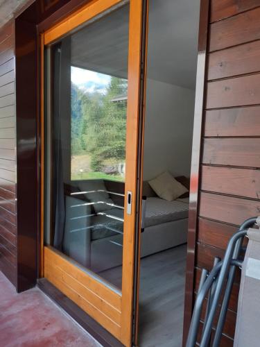a sliding glass door to a room with a couch at Appartamento Valfurva 15 in Santa Caterina Valfurva