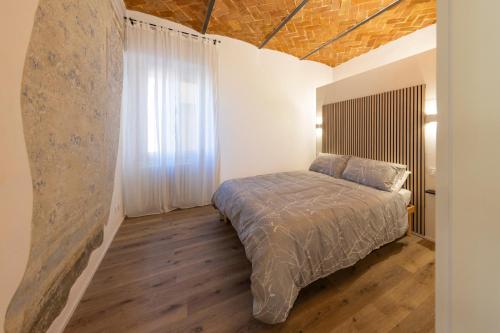 a bedroom with a bed and a large window at La Casina del Popi in Arezzo