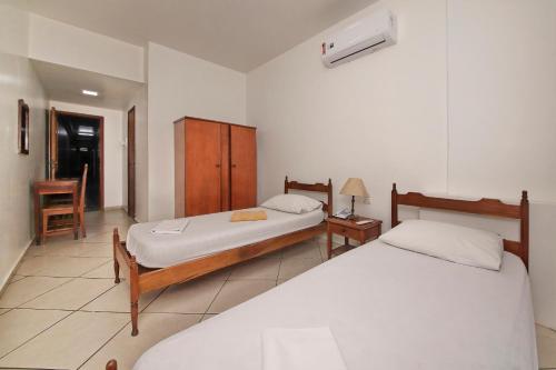 Ένα ή περισσότερα κρεβάτια σε δωμάτιο στο Hotel Macabu