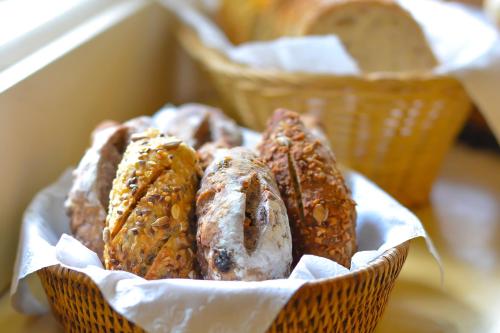 a bunch of food in a basket on a table at Villa Coração Guesthouse by Concavus in Monte Verde
