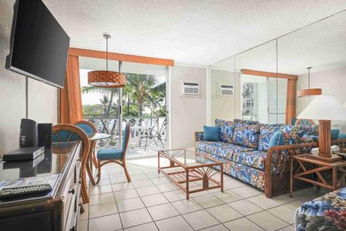 a living room with a couch and a table at Kona Islander in Kailua-Kona