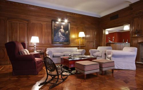 a living room filled with furniture and a fireplace at Solar De La Plaza in Salta