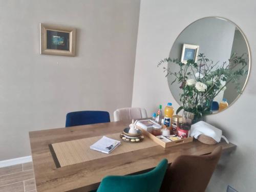 a dining room table with a mirror on the wall at Martin Pescador in Puerto Montt