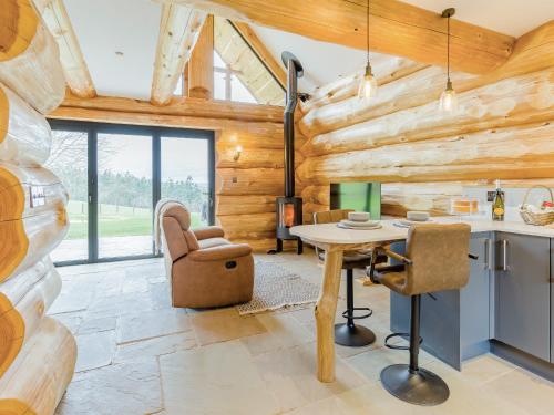 a kitchen and living room with a table and chairs at Hope Hideaway 