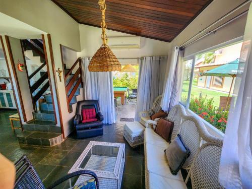 a living room with a couch and a table at Paraíso dos Corais - Casa 40 in Paripueira