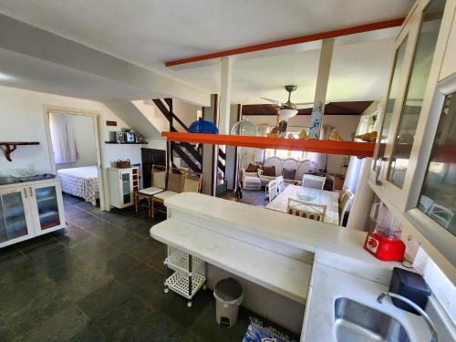 a room with a kitchen and a living room at Paraíso dos Corais - Casa 40 in Paripueira