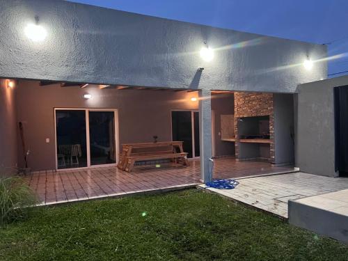 a house with a patio with a wooden bench at Quinta Los Barrera in Cañuelas