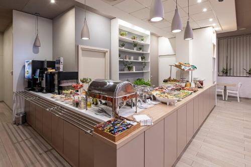 a buffet line in a restaurant with food on it at B&B Hotel Łódź Centrum in Łódź